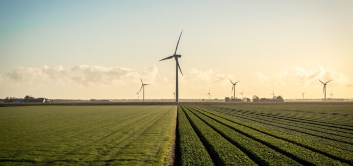 Wind mill generating clean energy, a renewable resource that can help reduce the carbon footprint of the fashion industry.