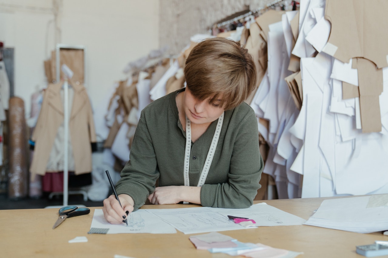 Image of a quality control inspector making quality report. Implementing a strong quality control system in your garment manufacturing company can improve the overall quality of your products, reduce errors, and ensure customer satisfaction.